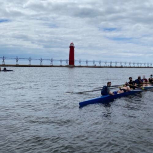 Rowing boats row to Lake Michigan in teams of 8.